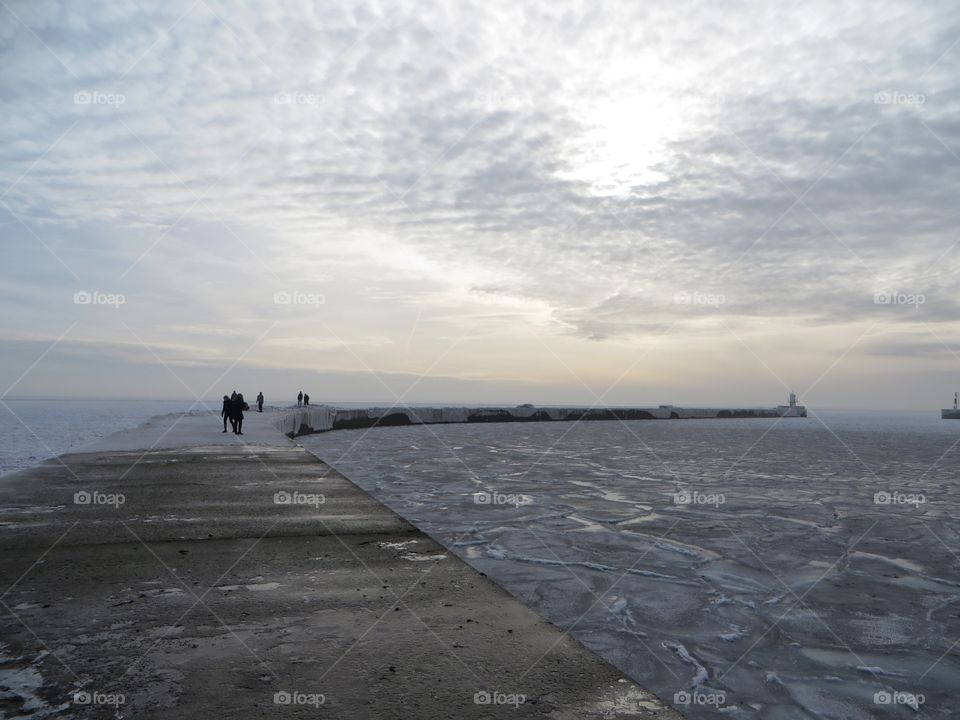 Peoples on pier at frozen sea