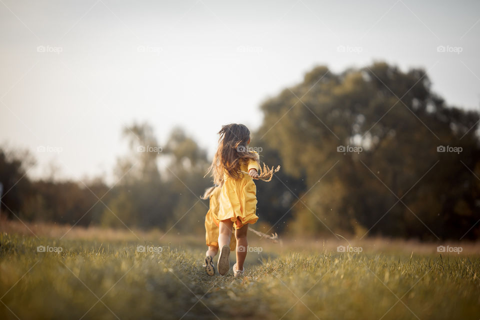 Little girl in yellow dress outdoor portrait 