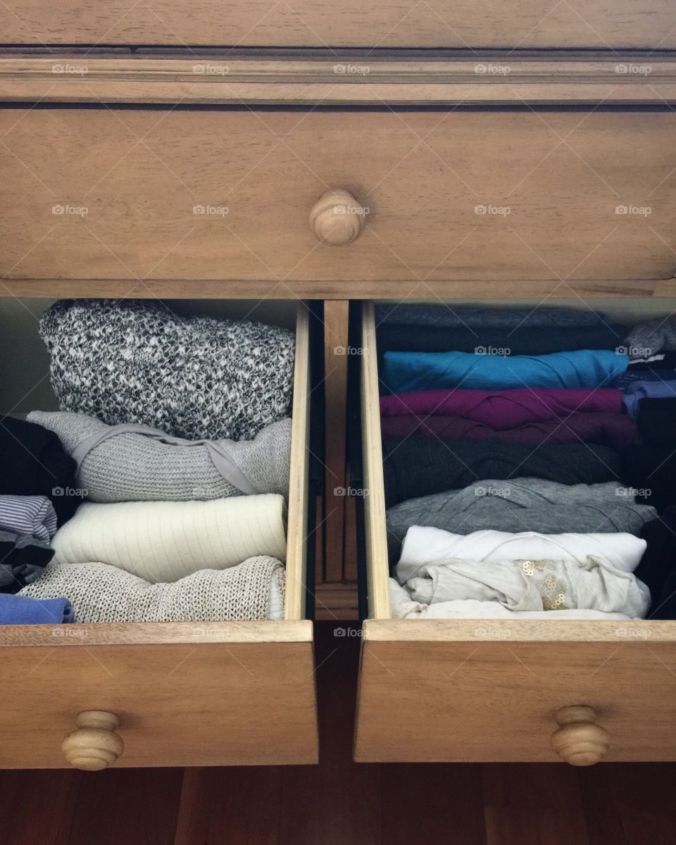 Tidy dresser drawers with shirts and sweaters folded for easy storage