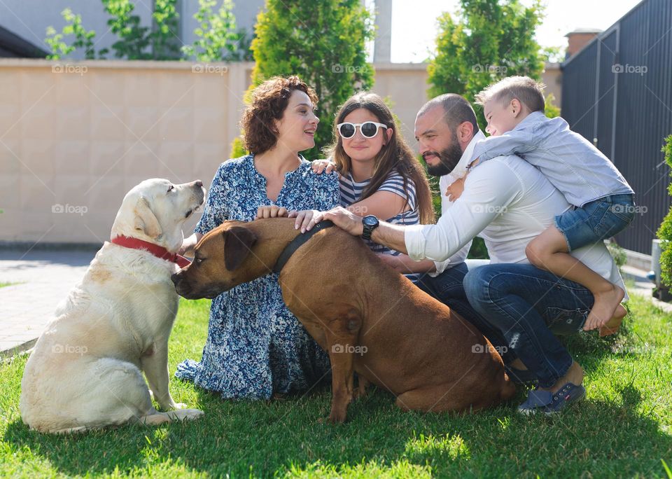 walking the dog down the street, the owner walks the weakling, teaches her, cleans up after her, educates, plays with his pet. people and dogs are best friends, big family 