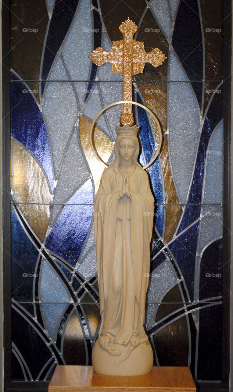 statue and stained glass. Mary