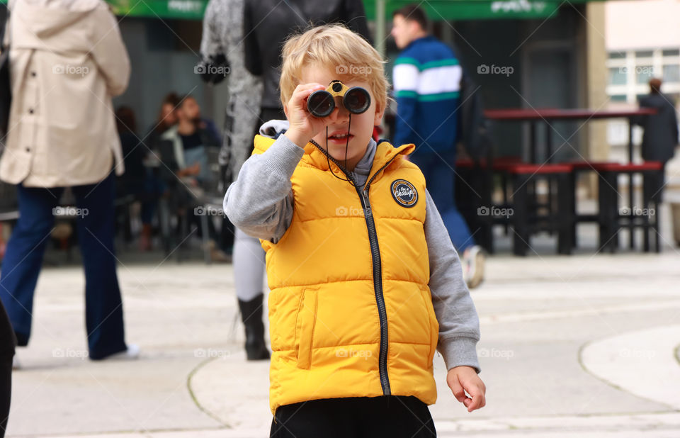 Little boy in yellow vest