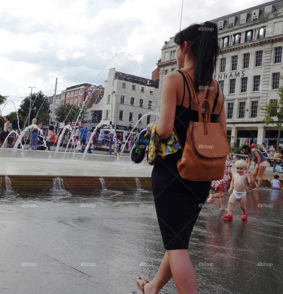 People cooling of in the fountains at Old Market Squar in city centre of Nottingham, England