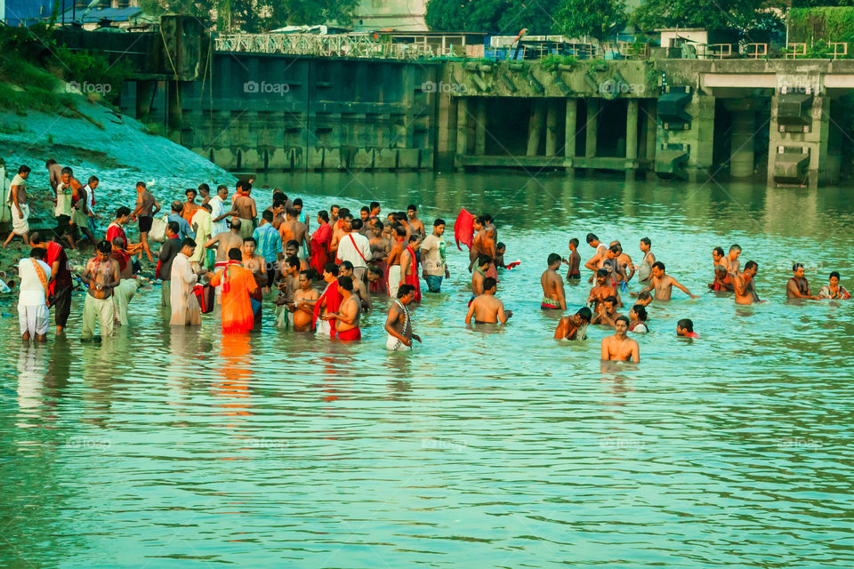 KOLKATA, INDIA - JANUARY 14, 2016: Devotees taking holy dip at Har Ki Pauri on river Ganga on the first bath of Ardh Kumbh fair. People took a dip in holy Ganges on the occasion of Makar Sankranti