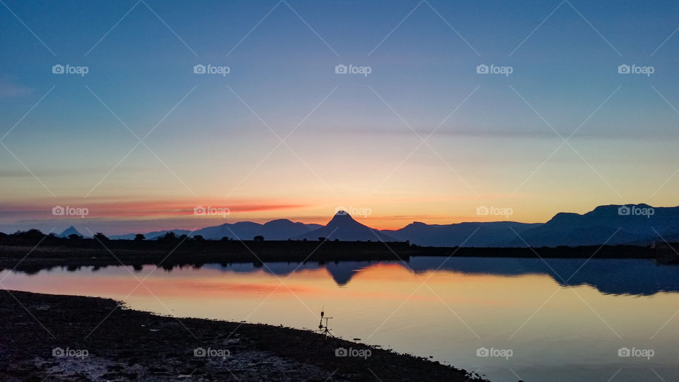 sunset with mountains on a lake
