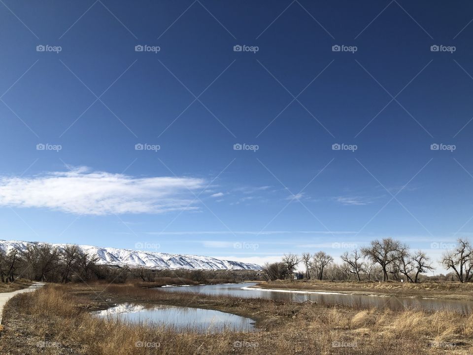 River with snow covered mountains in the distance