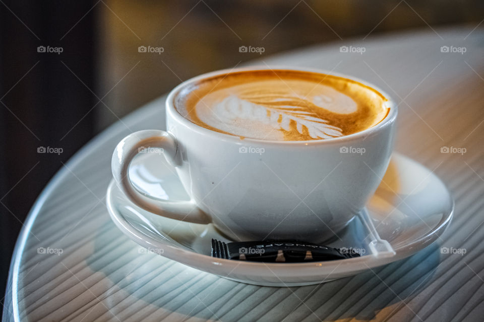 Coffee latte in beautiful white salt on a white table