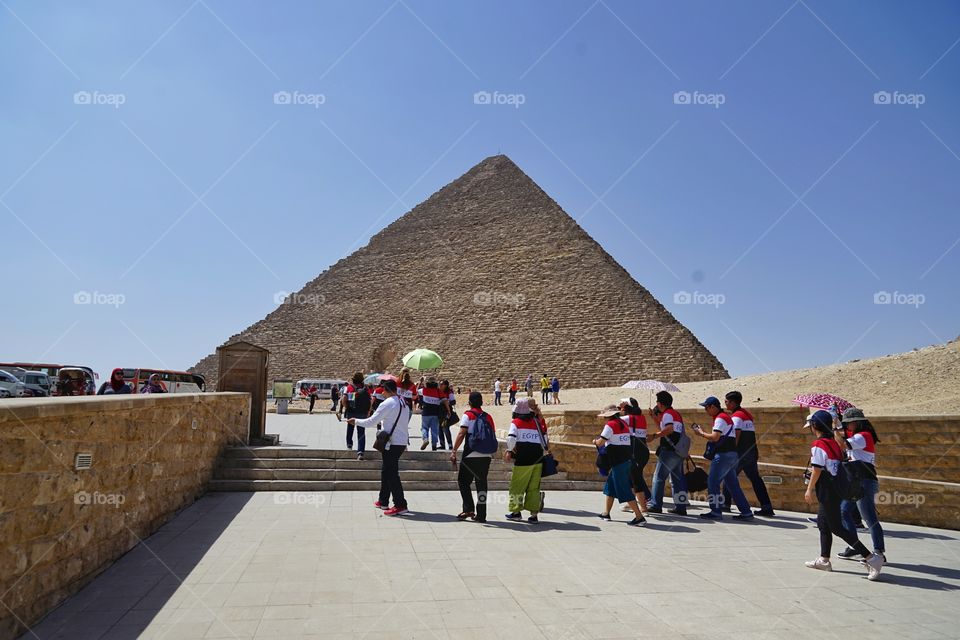 a group of tourists at Pyramid of Giza in Egypt