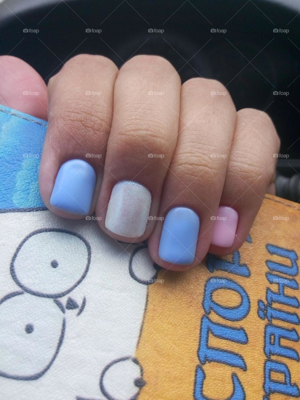 Nude sky blue manicure with Ukrainian passport