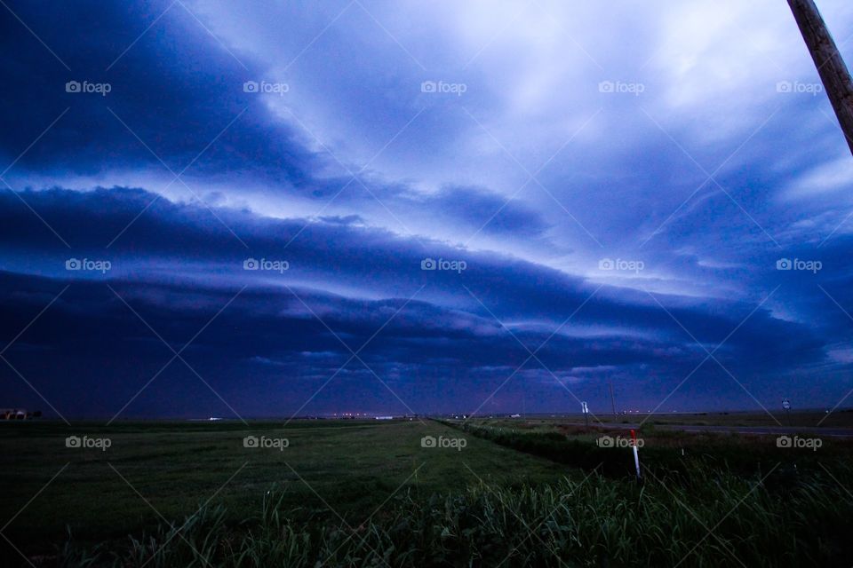Severe line of storms rolling across open fields 