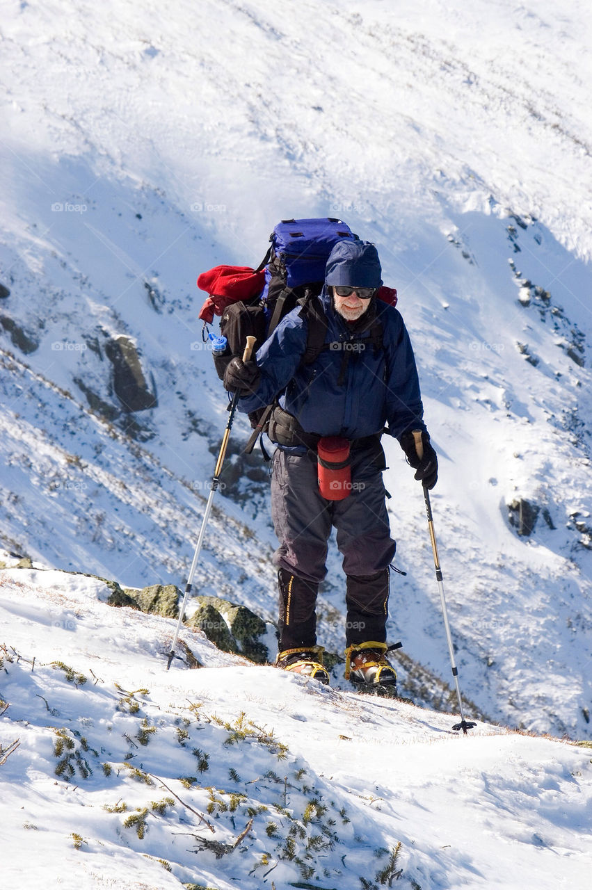 Backpacker hiking along the summits of the presidential Range in the