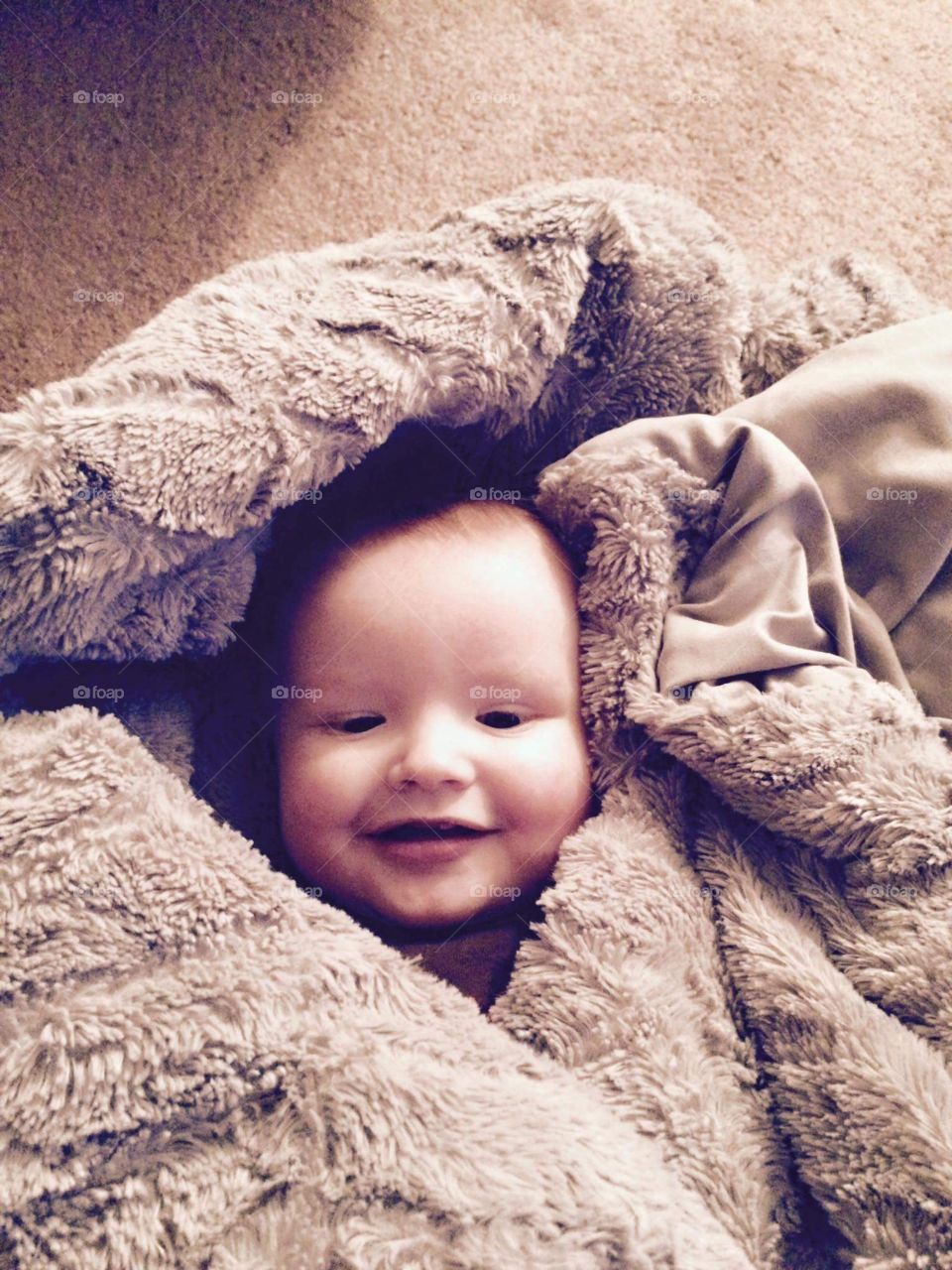 happy baby in blankets