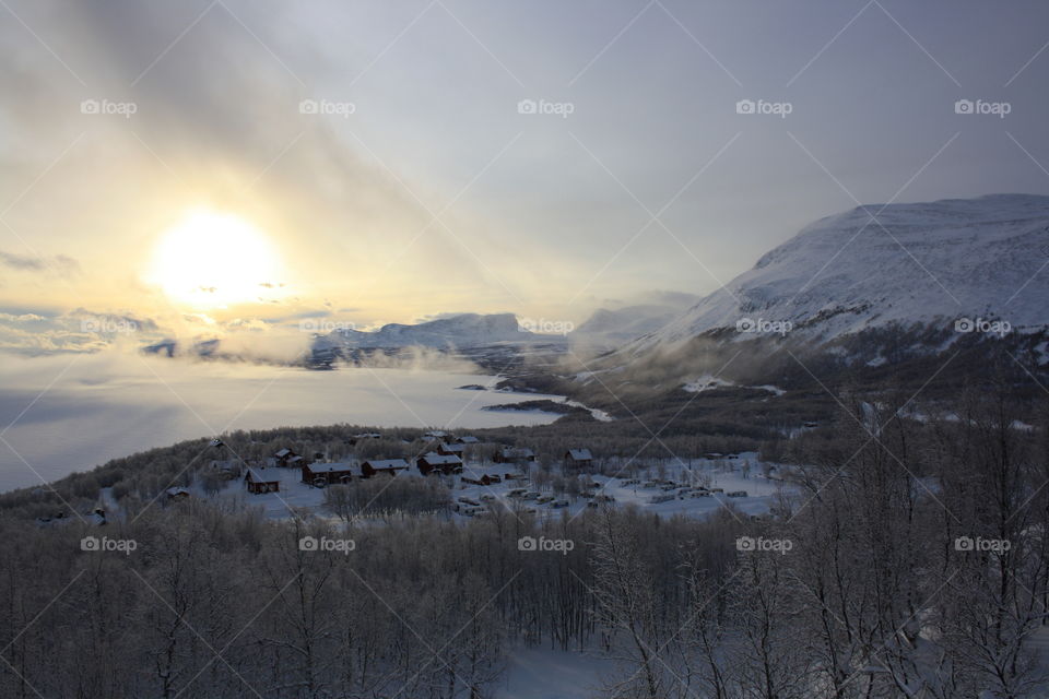 Misty morning over snowy mountain