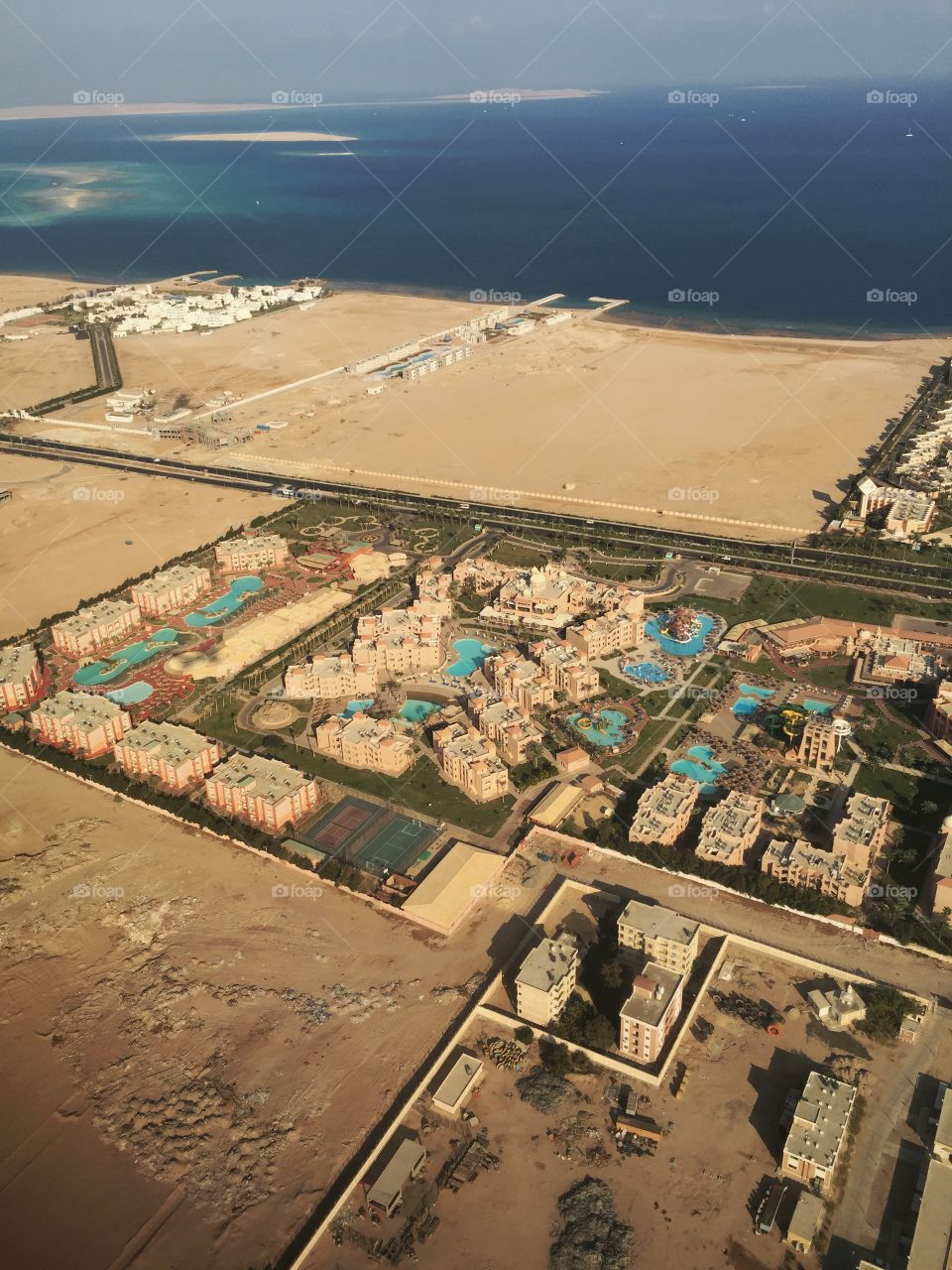 View from above on desert and hotels on the coastline