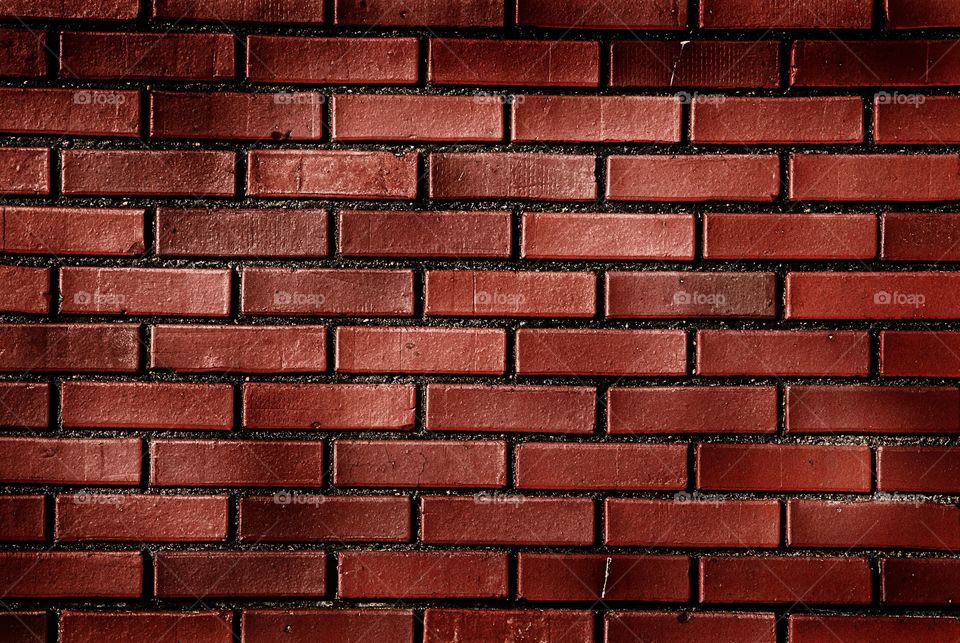 Mottled lighting on a brick wall background 