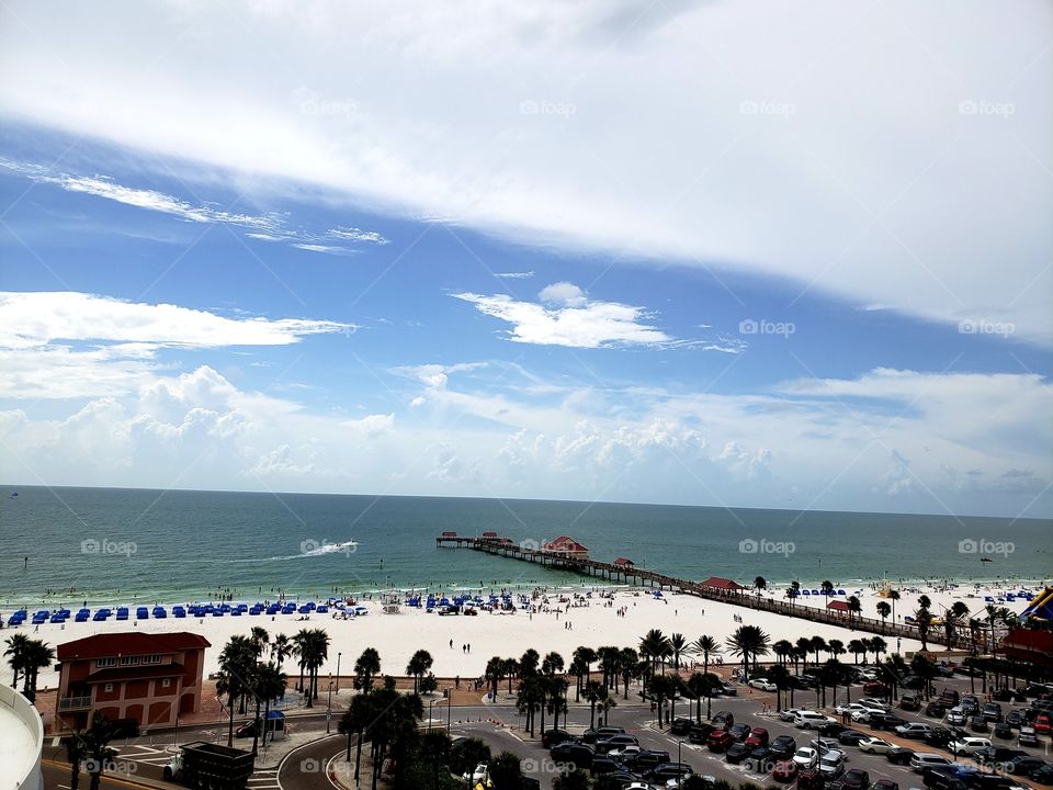 View of Clearwater Beach and Pier 60 from The Crow's Nest. Beautiful sunny day with storms out in the Gulf.