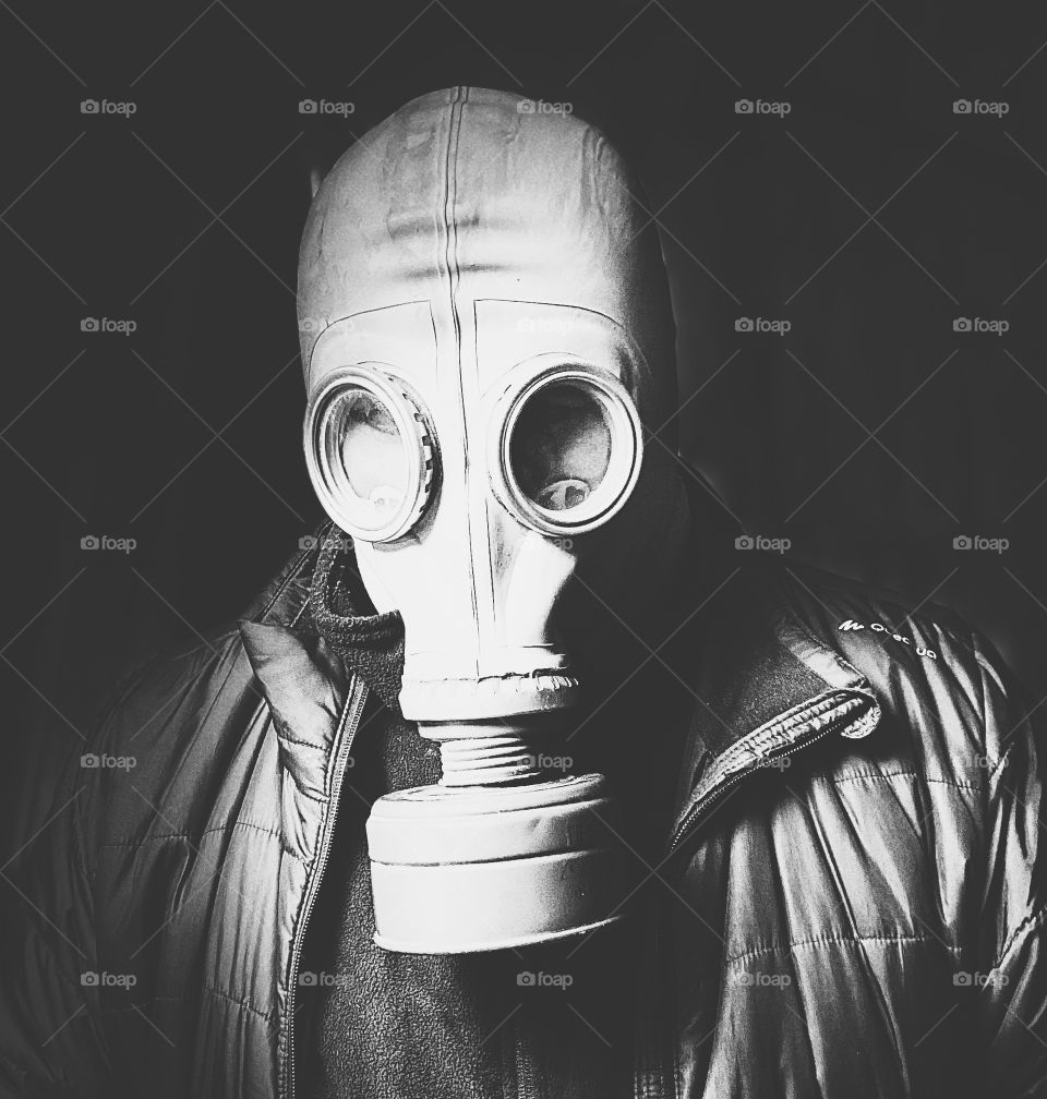 Black and white portrait of a man in a gas mask