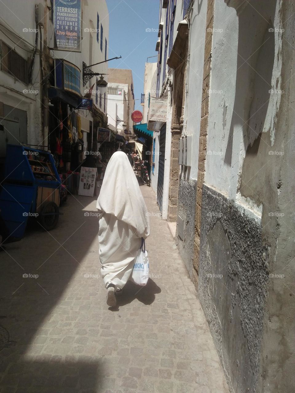 An old woman wearing traditional moroccan clothes at essaouira city in Morocco.