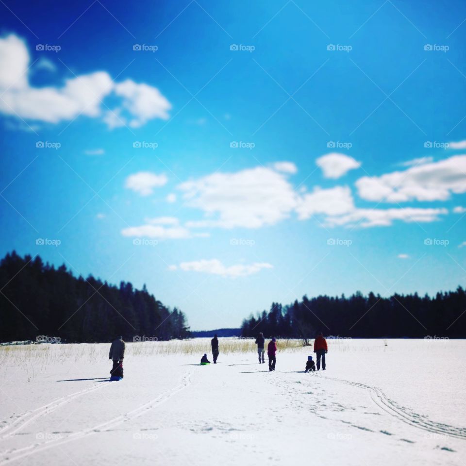 Family walk on frozen lake