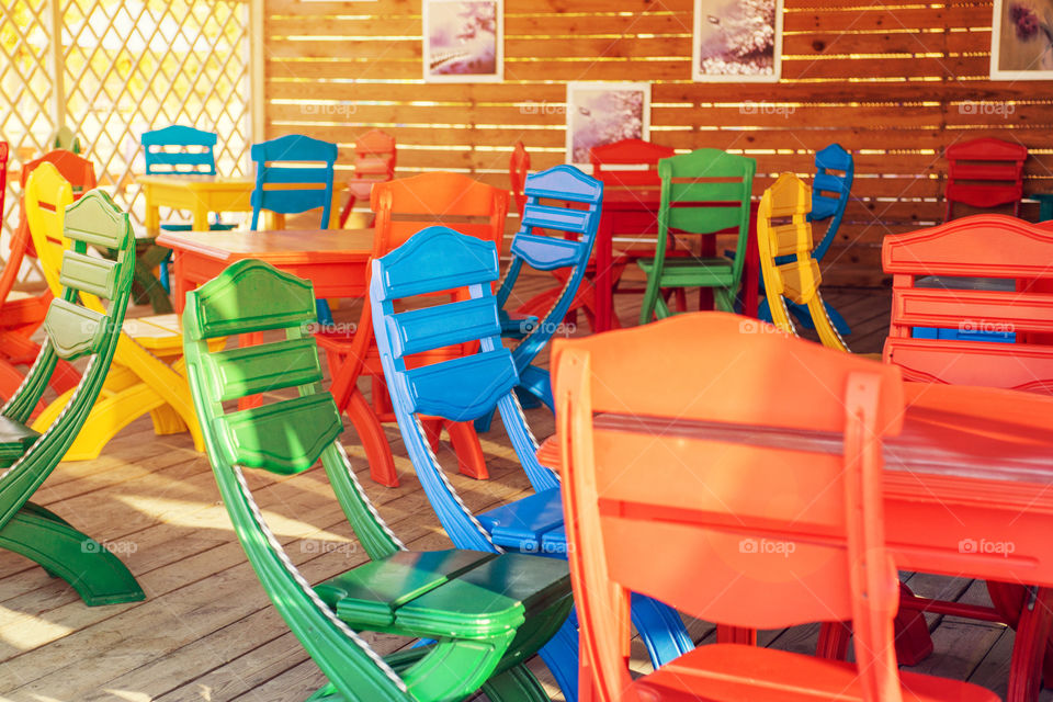 Summer terrace cafe, plastic colorful multi colored chairs outside