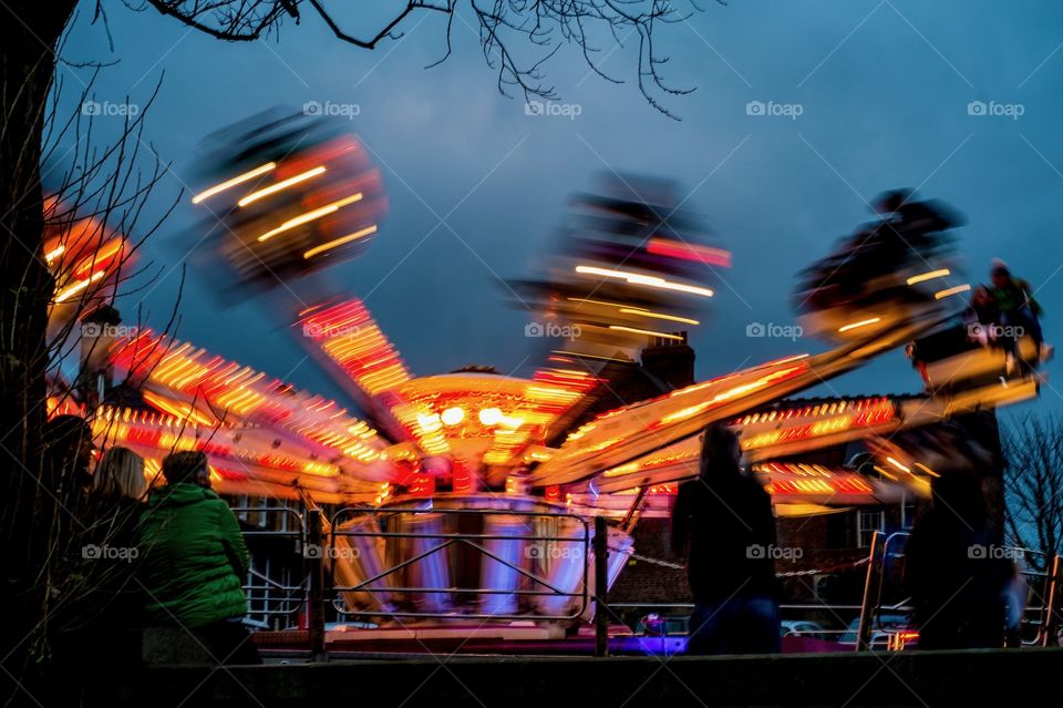 Blurred motion shot of fairground ride at night