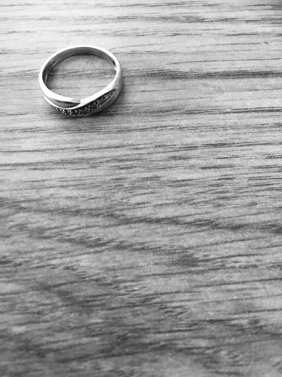 Wedding ring on wooden surface in black and white. Marriage- so emotive means so many different things to so many different people. Perhaps an element of loneliness here...?