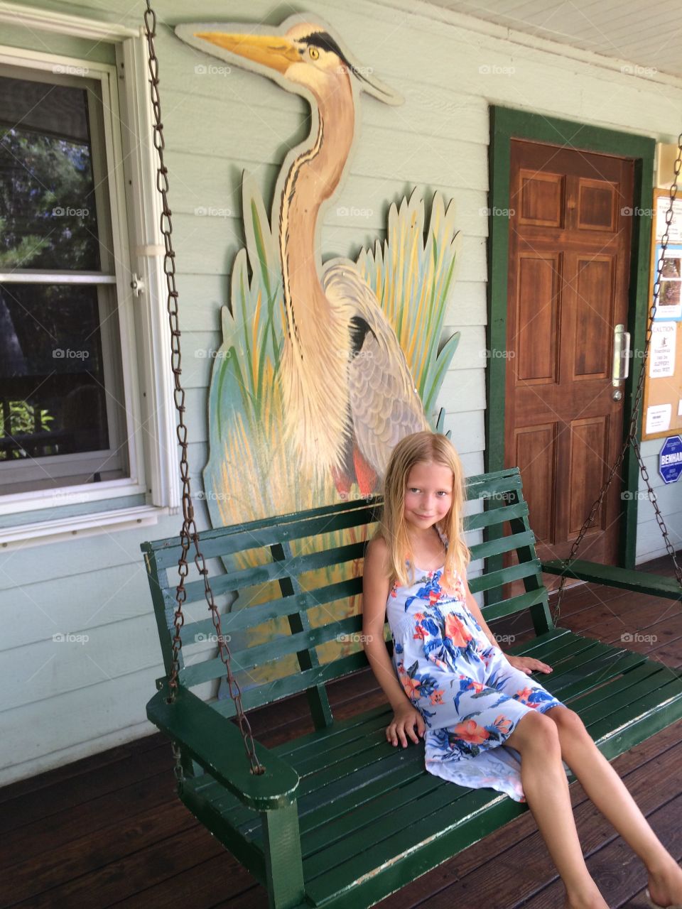 Little girl on a porch swing 