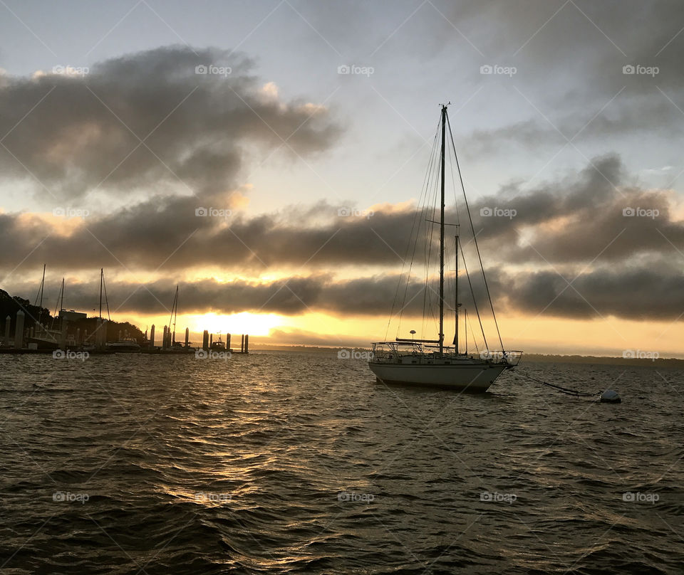 Sunrise on the water with sailboats