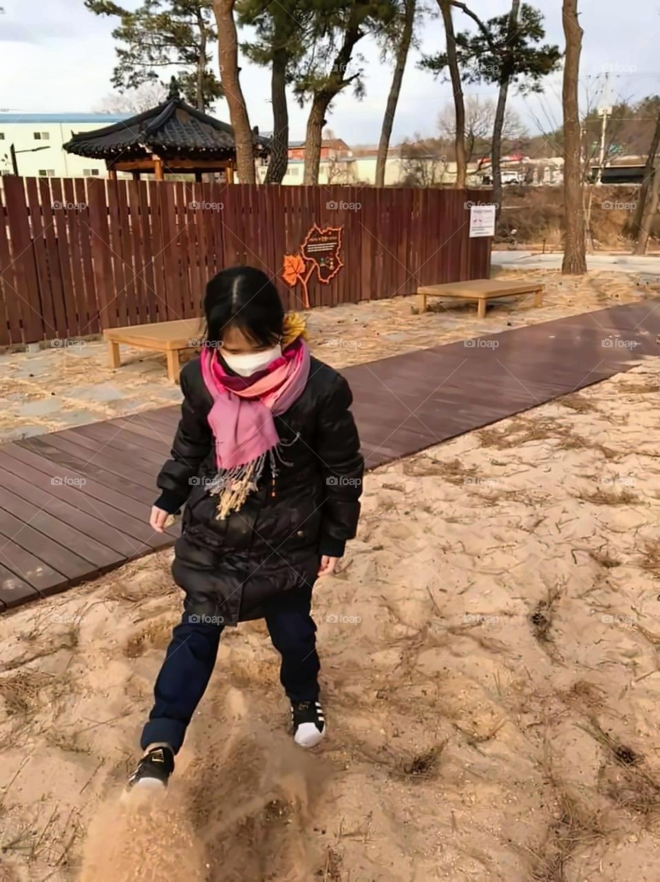 kicking the sand , makes her more  happy.
