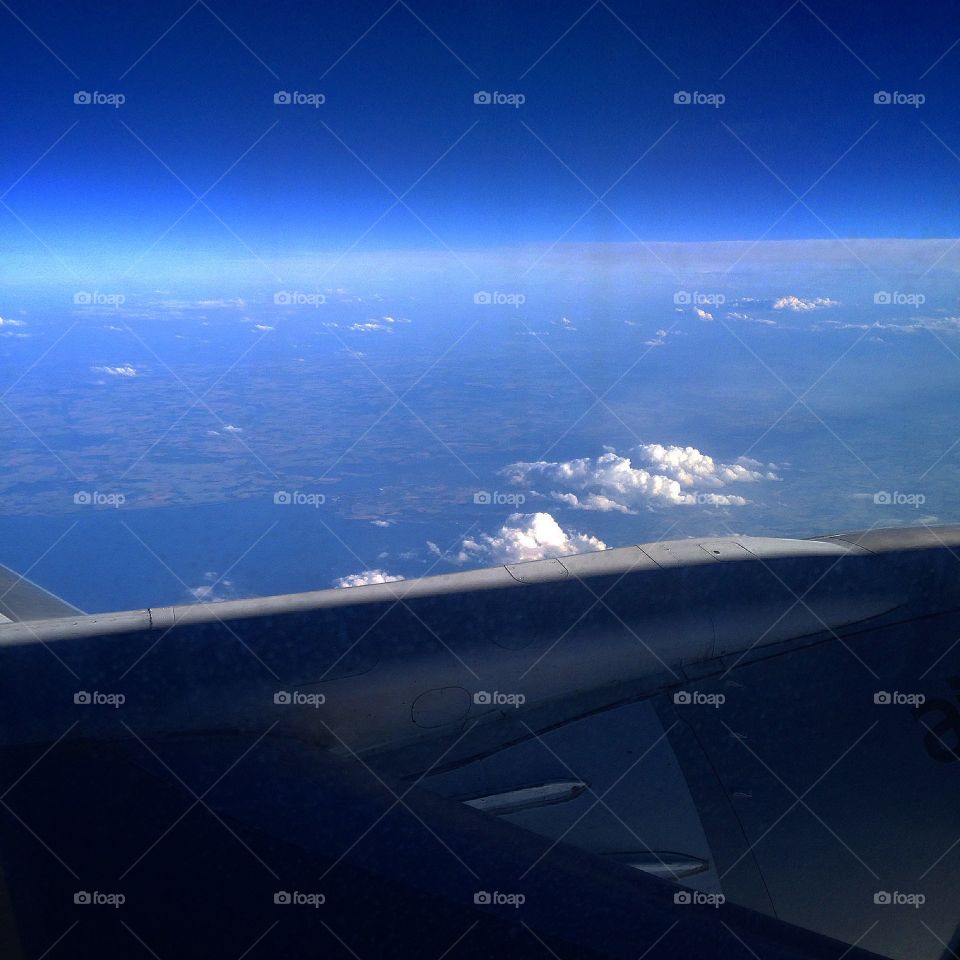 Photo of the clear blue sky taken from a plane view when travelling with Ryanair to Riga on holiday.