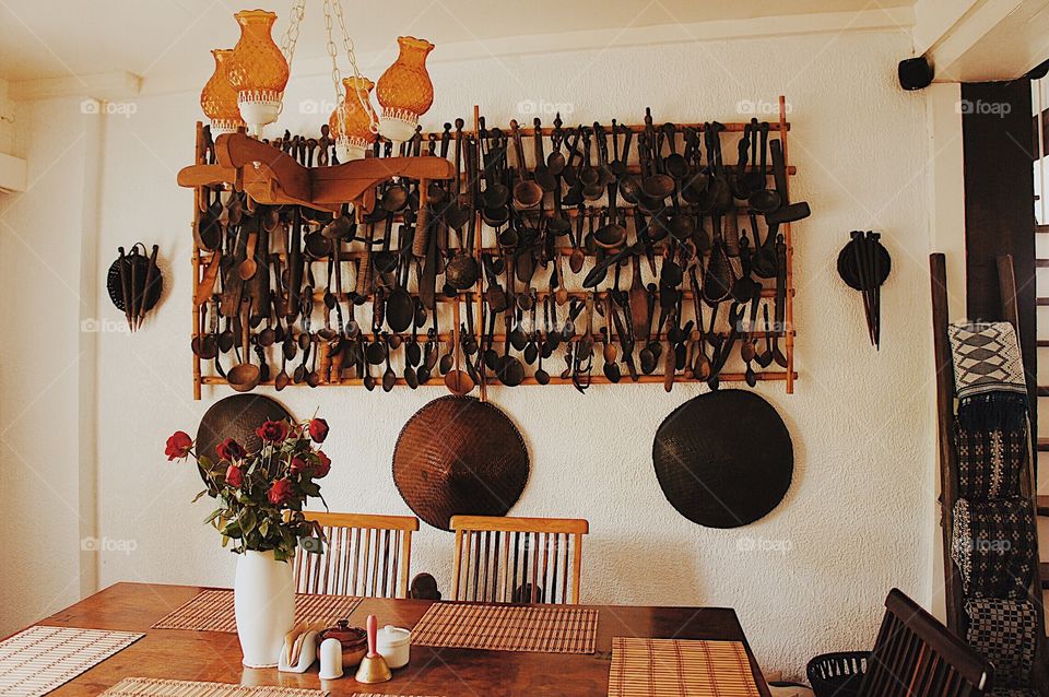 Dining area with ornaments hanging from the wall.
