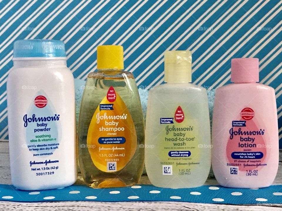 Johnson and Johnson baby lotion, shampoo, head to toe wash and powder on a blue and white background