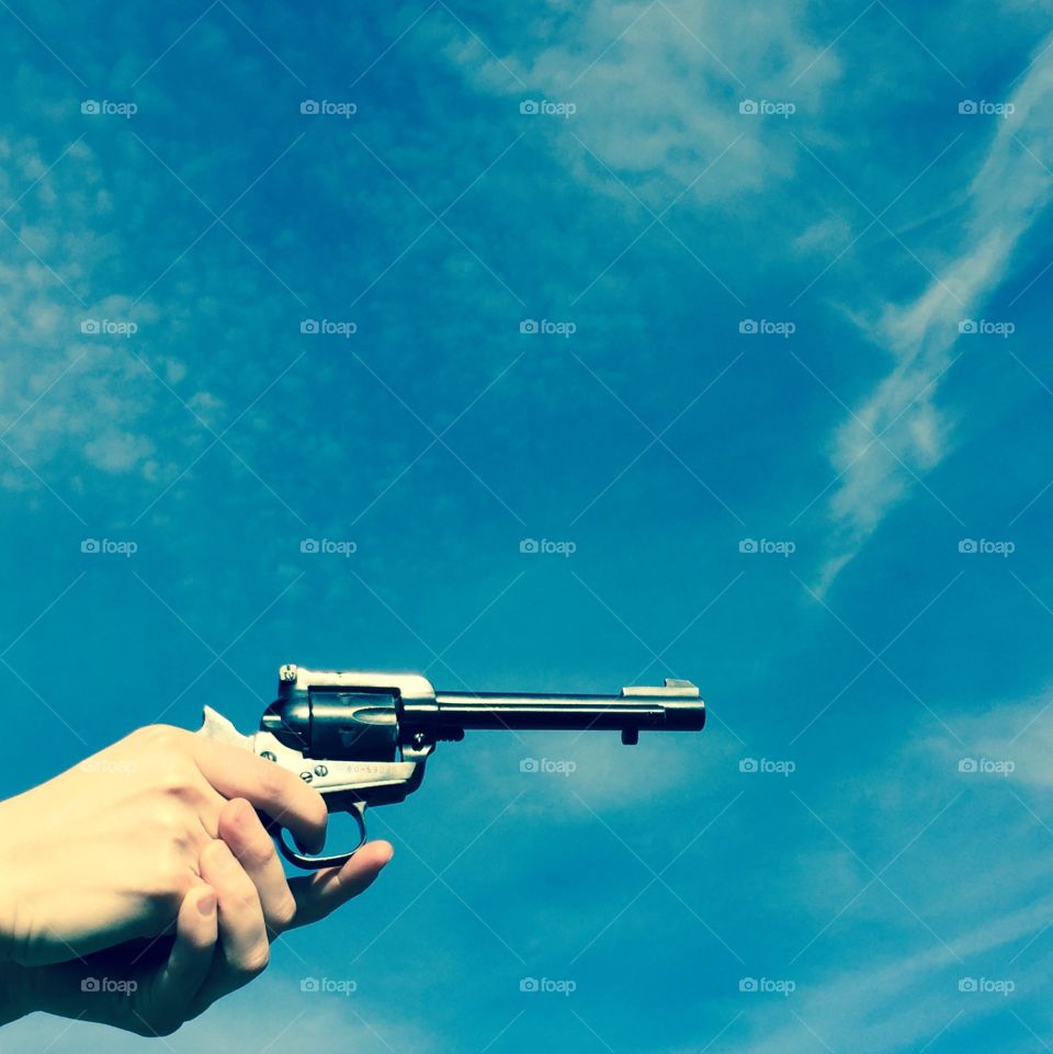 Pistol and blue sky