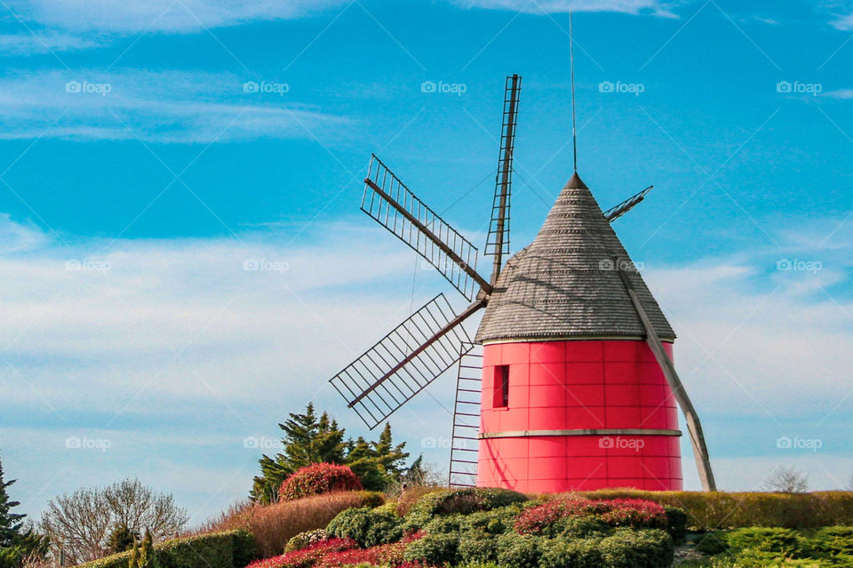 Red windmill with beautiful blue sky in summer