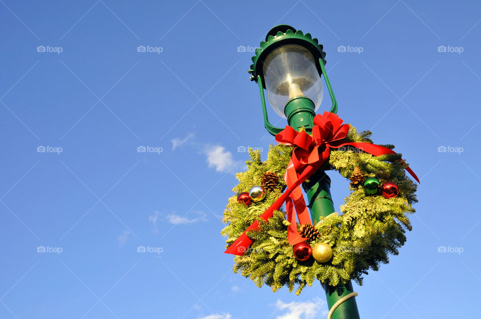 A lamppost is decorated for Christmas.