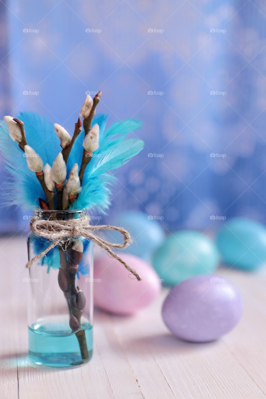 Easter eggs and willow branches in a vase