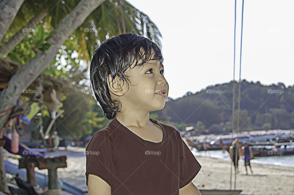 Portrait Asean boy Sitting on the beach, Koh Lipe at Satun in Thailand.