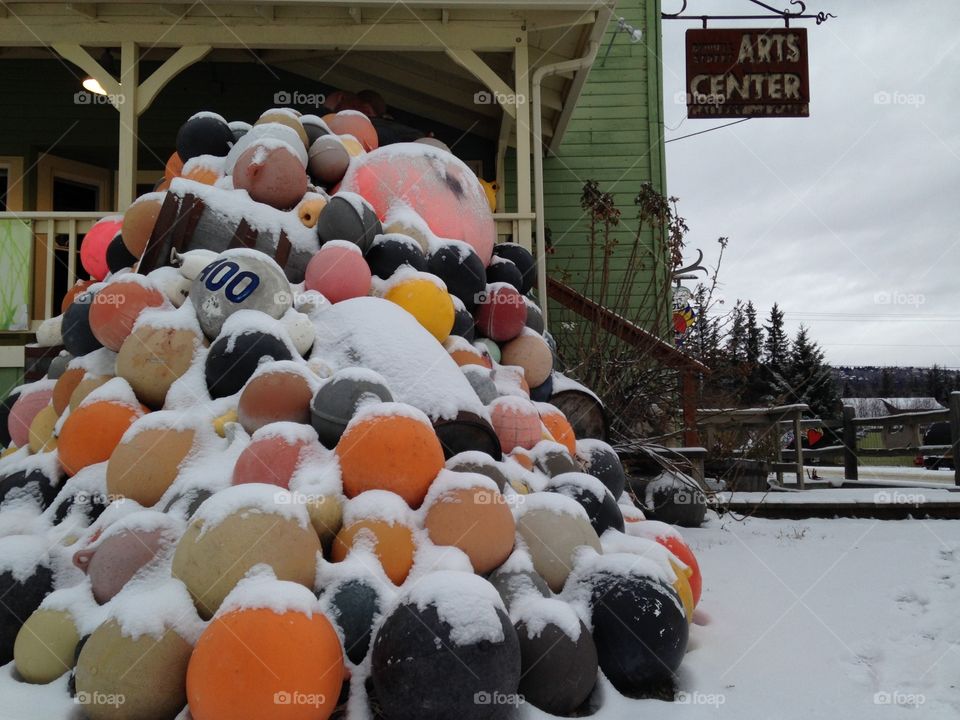 Snow covers this mound of bouys at a store front