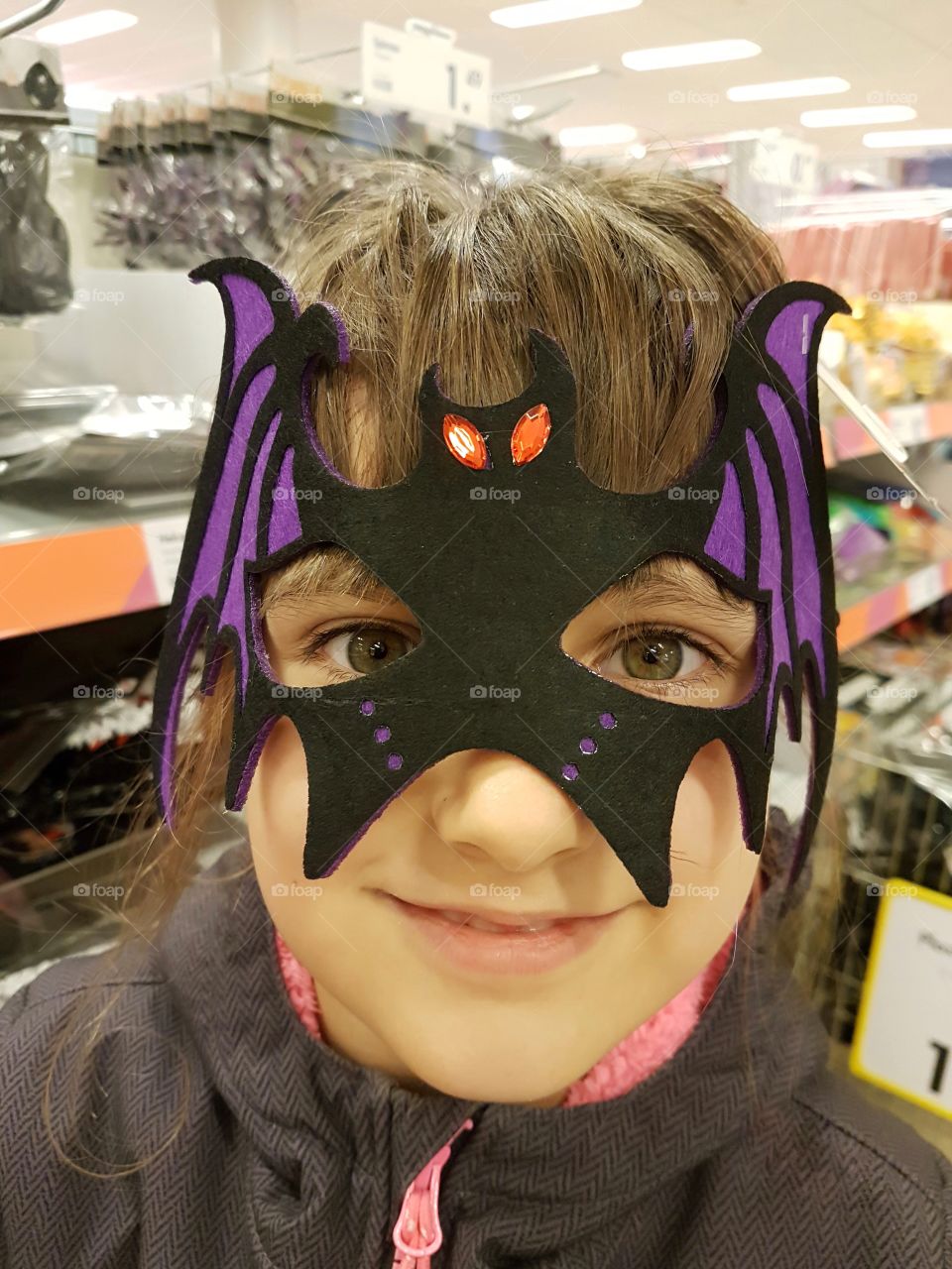 A girl in mask of bat for Halloween 