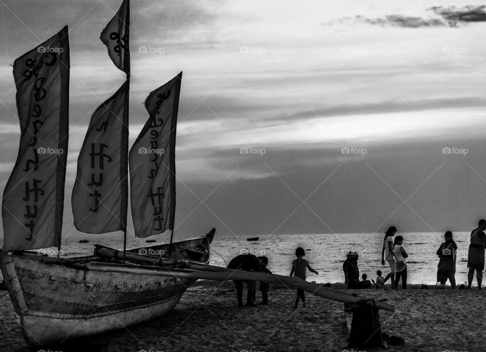 people at beach during sunset in monochrome