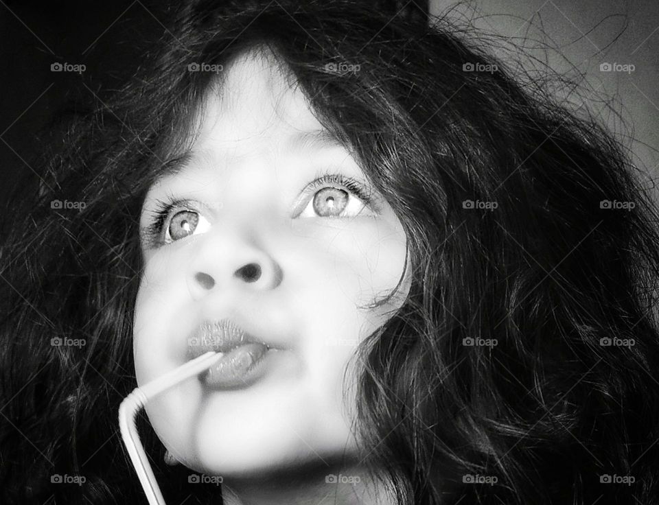 Vintage black and white frame , beautiful son with long wavy hair.His attractive eyes talk
because eyes are the window of the soul.