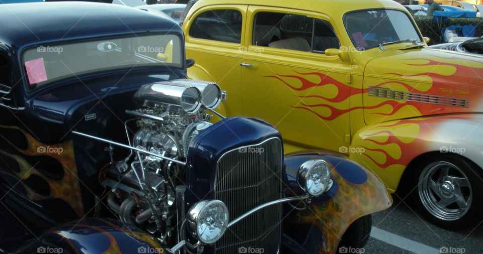 let's race! two colorful flame design roadsters at classic car show in California