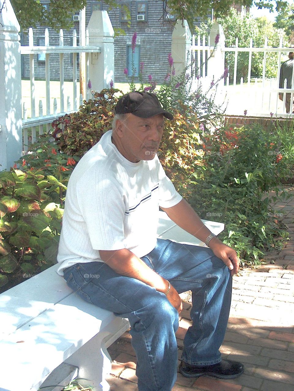 Senior adult man suiting on bench in park