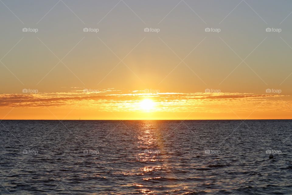 Bright orange red sunrise over the ocean 