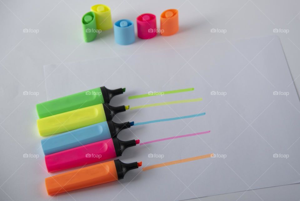 Colored markers on white background