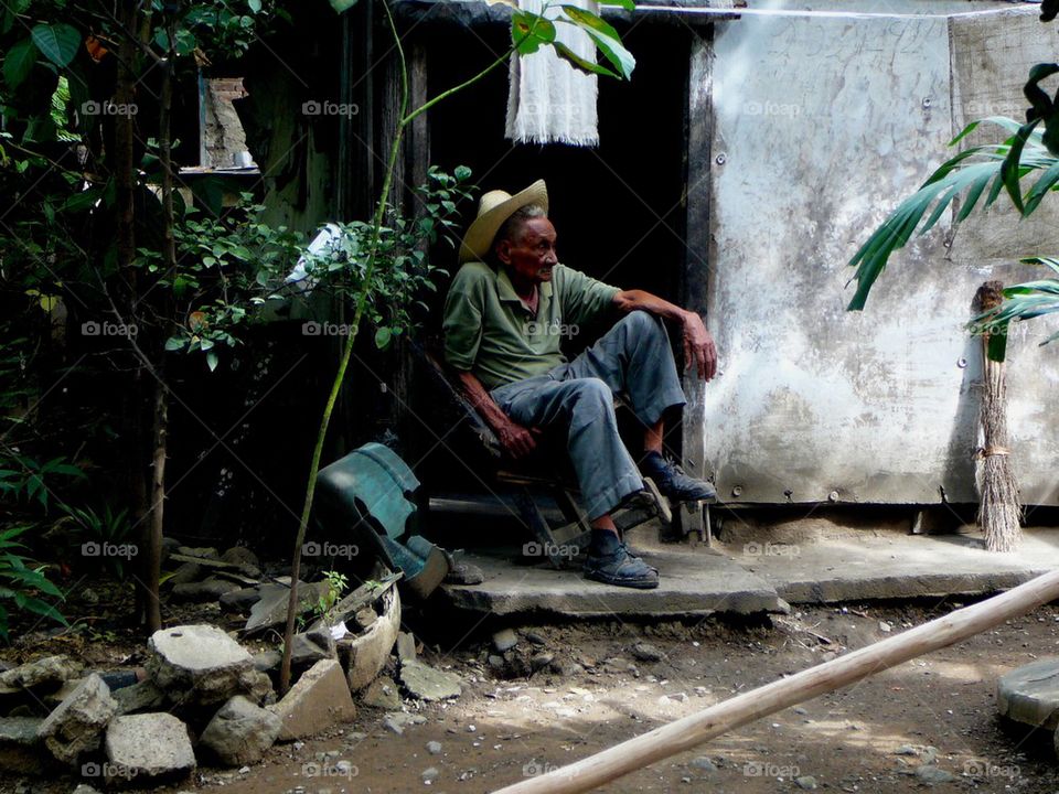 A home is a men's castle . This 90 year old man is resting at home