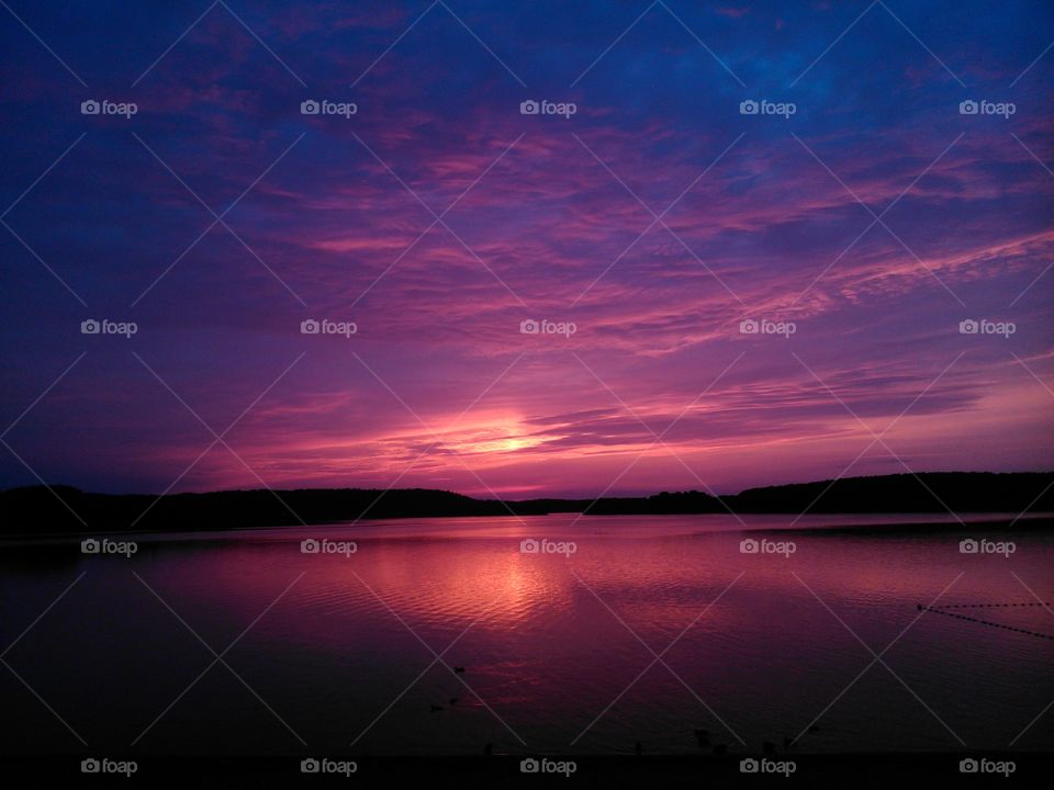 Scenic view of idyllic lake at sunset