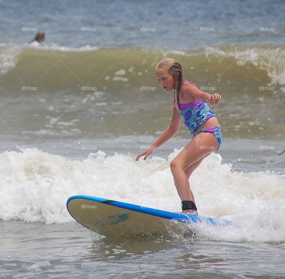 Girl learning to surf