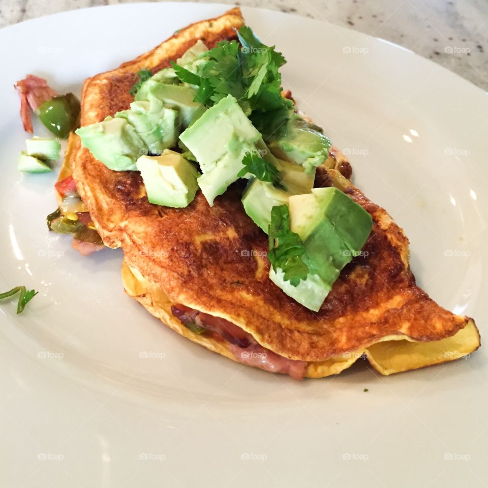 Avocado omelet. Great breakfast made with Southwestern style Egg Beaters, ham, bell peppers, onion, avocado and cilantro!