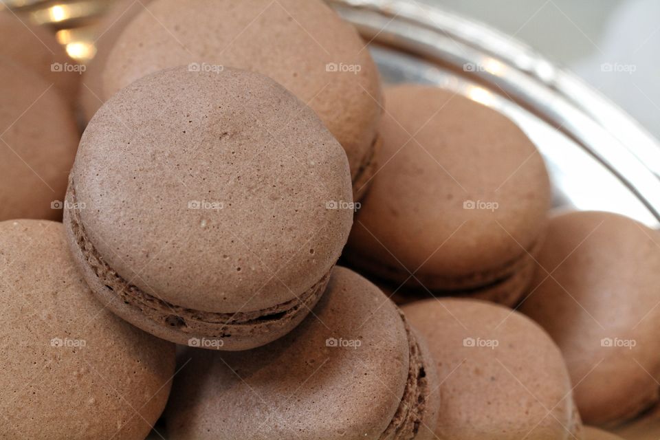 A pile of chocolate macaroons or macarons.